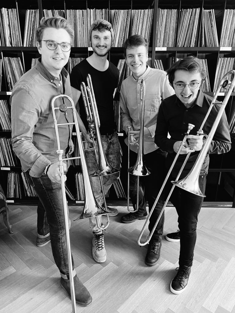 Foto shows the four members of the Millennium trombone quartet with their instruments